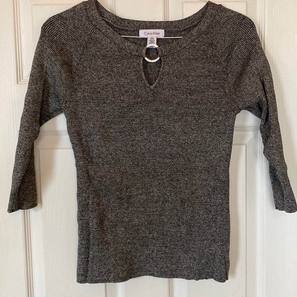 Like new Calvin Klein 3/4 sleeve sweater with metal detail. Women’s Size Large